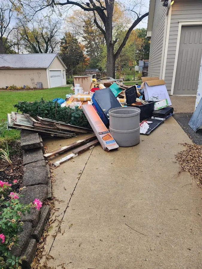 Dumpster being loaded with debris for 12 Yard Dumpster Rental in Angleton